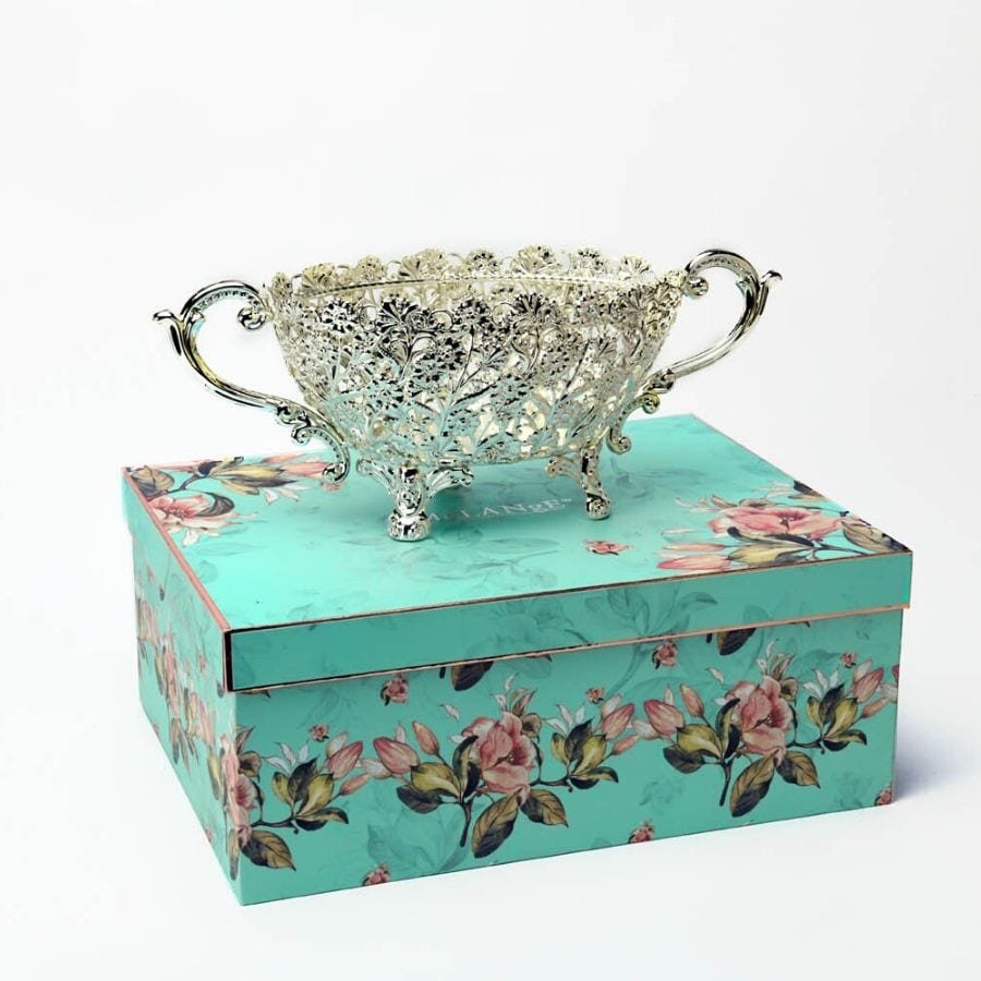 a Silver plated Cutwork Basket with detailed handles and designer legs placed on a gift box