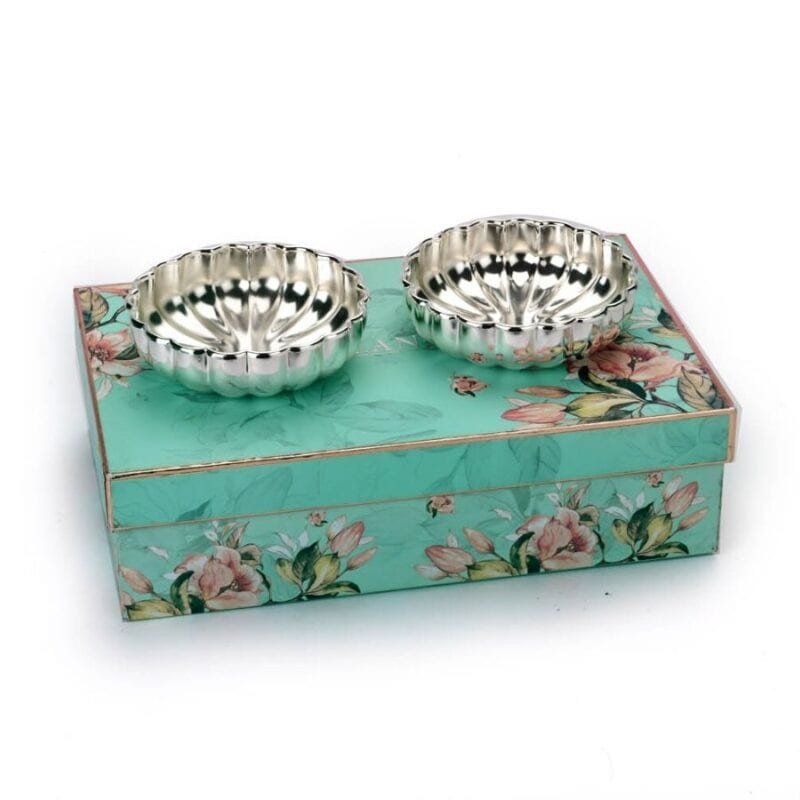 a set of two silver plated bowls with a fluted interior placed on top of a beautiful gift box