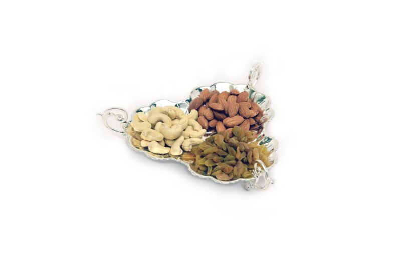 a three sided silver plated platter to serve premium dry fruits