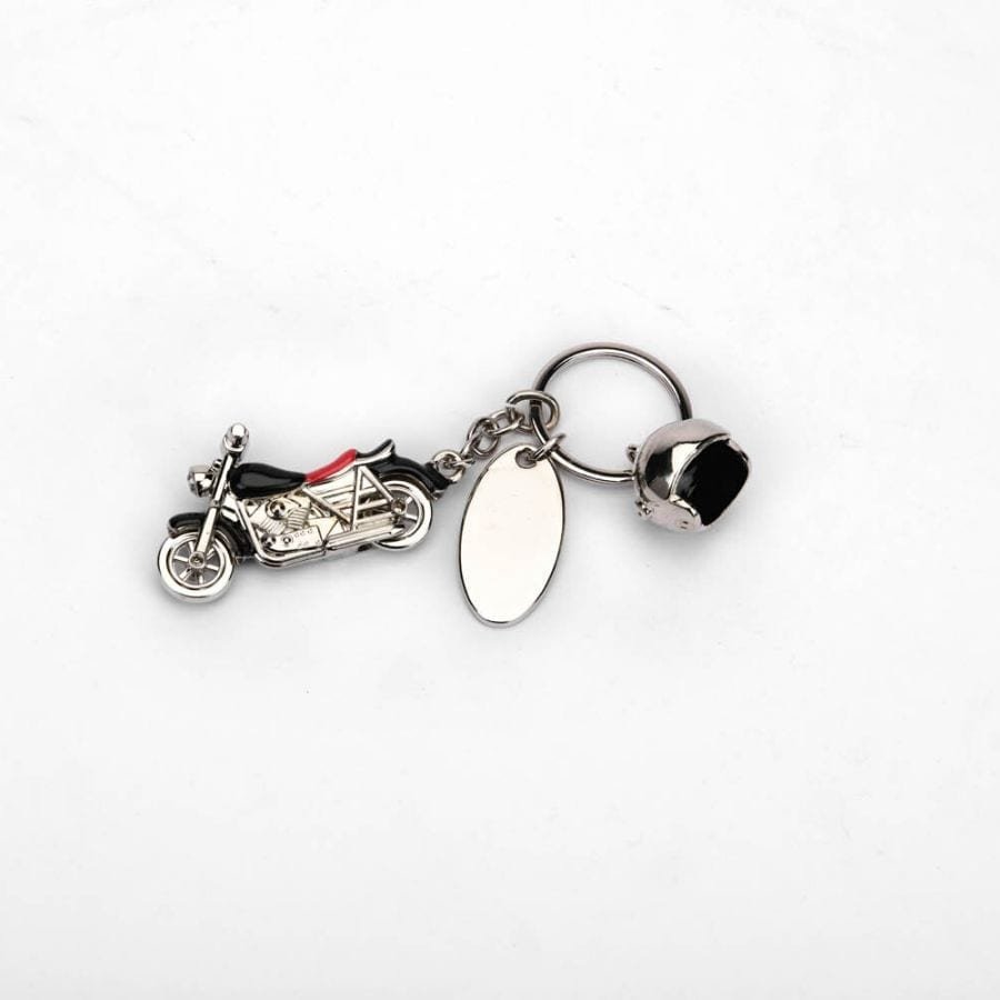 a silver plated Keychain of a bike and a helmet