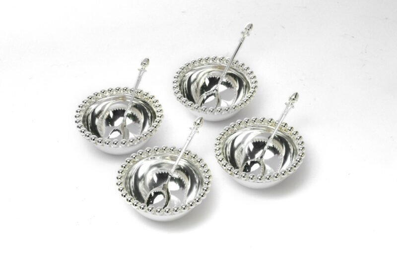 a set of four Ball Beaded silver bowls with spoon