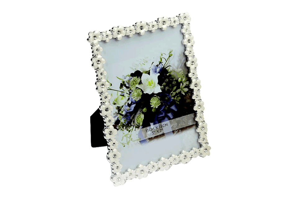 A Photo frame decorated with enameled & crystal studded flowers on its four borders having a photograph requirement of 13 into 18 centimeters
