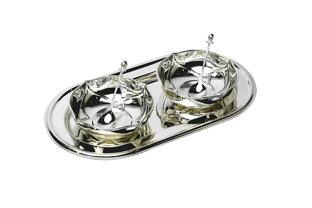 a set of two silver bowls with a scalloped interior placed on a silver tray and spoons