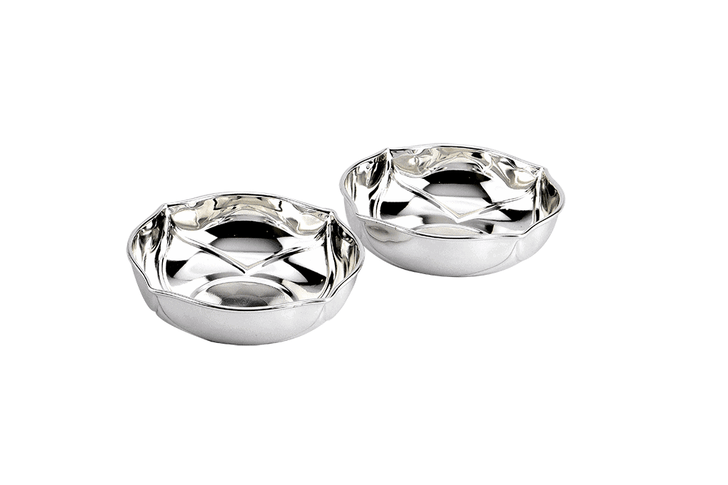 a set of two silver bowls with a scalloped design interior