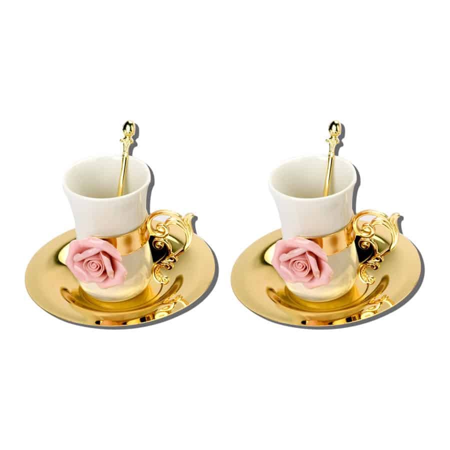 A set of two golden ceramic cups with saucers, spoons, detachable handles with pink flowers