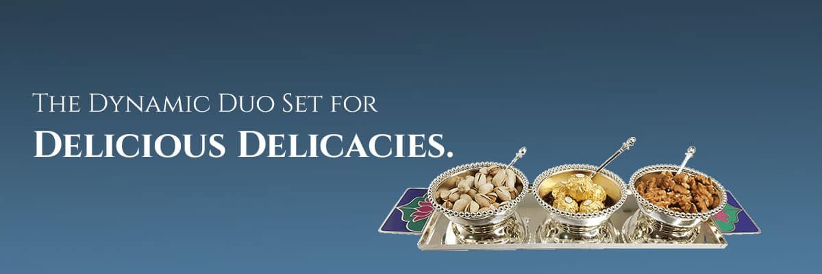 a blue banner showing a silver tray with bowls & a sentence saying - the dynamic duo set for delicious delicacies.