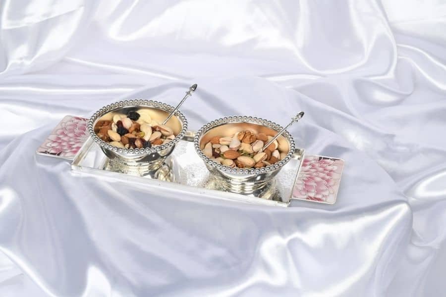 silver plated tray with two bowls full of dry fruits