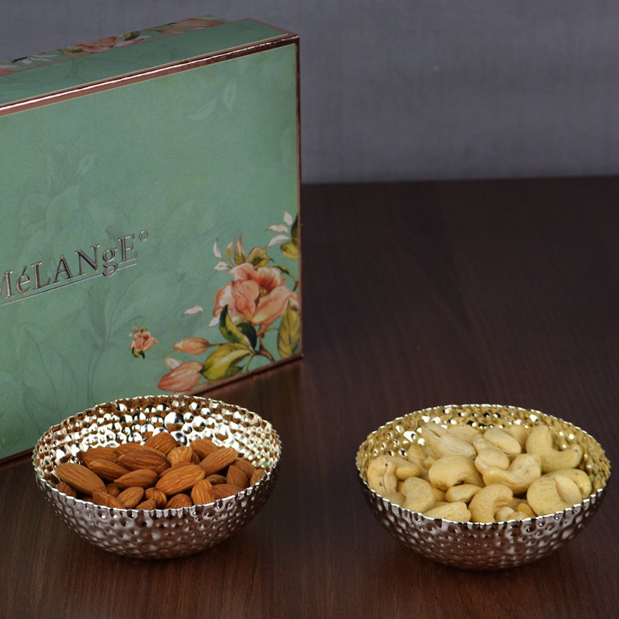 Dot Hammered Fruit Bowls one containing almond and other containing cashews and a gift box in aqua color kept in the back.