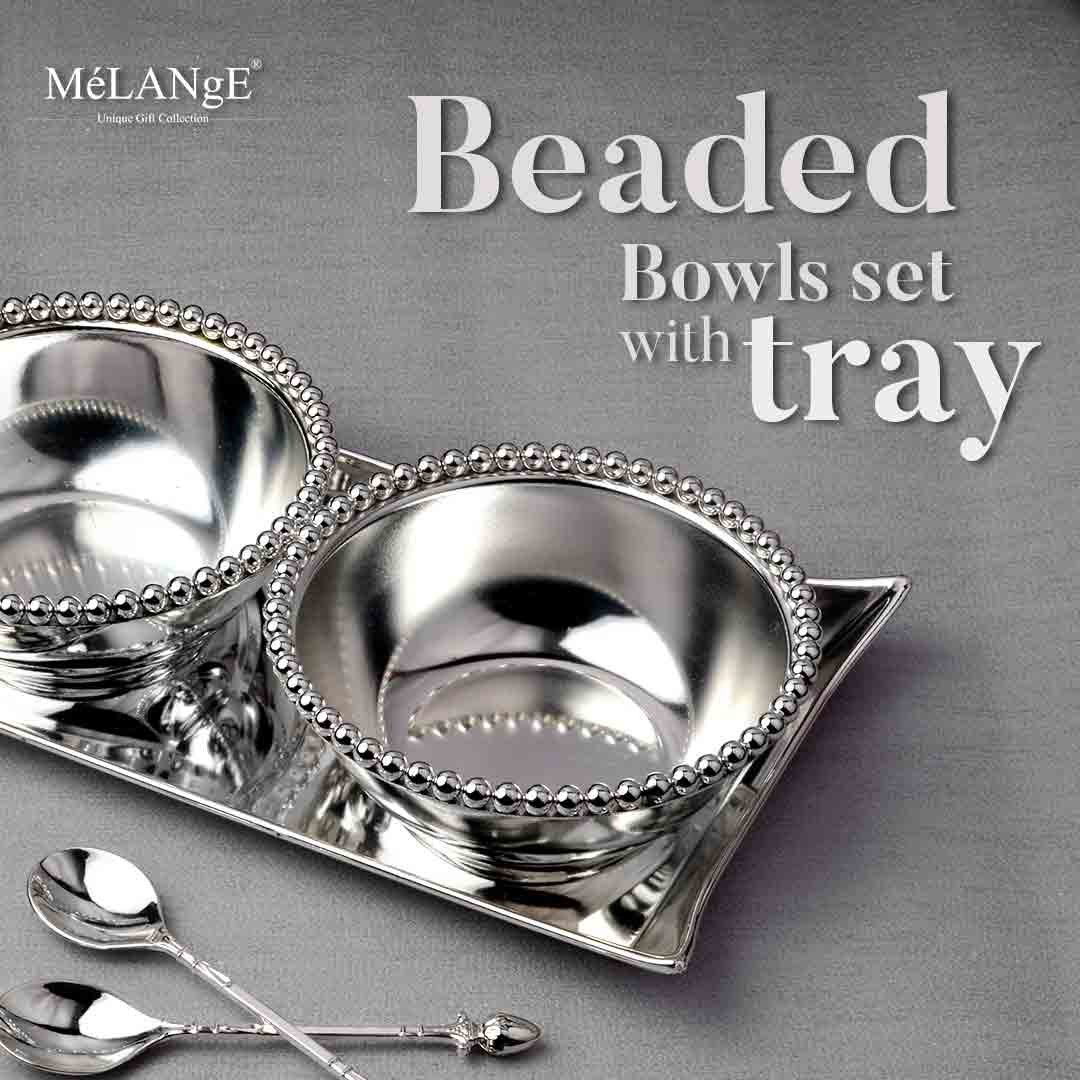 Beaded, silver-plated Bowls Set with Tray and Spoons are placed in the picture.