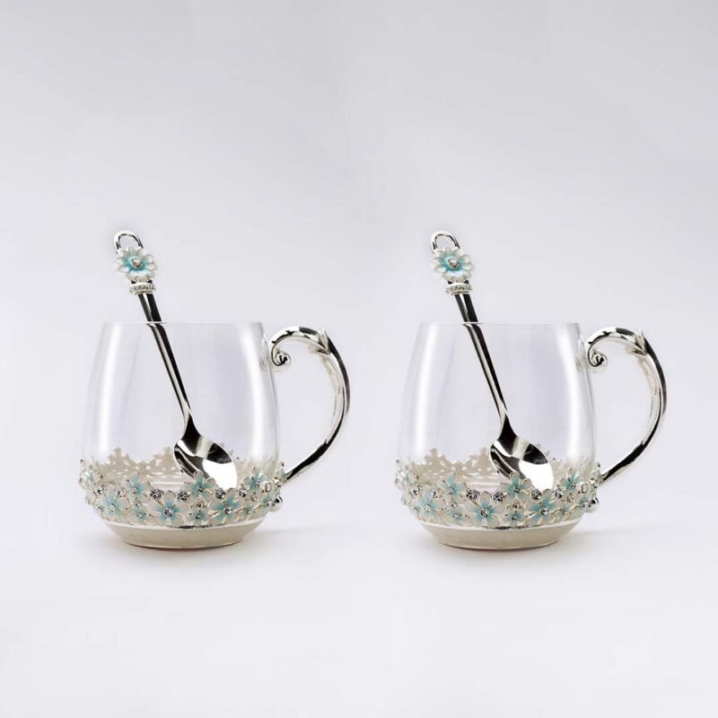 Silver-plated Mugs with enameled flowers on the bottom paired with spoons with identical flower motif.