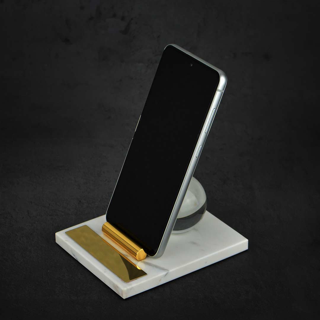 Crystal Globe Mobile Holder With A Mobile Phone Kept Against A Black Background.